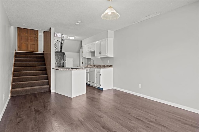 kitchen with dark wood-style floors, baseboards, white cabinetry, a sink, and dishwasher