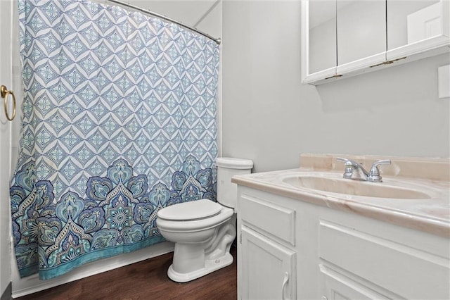 bathroom with vanity, curtained shower, toilet, and wood finished floors