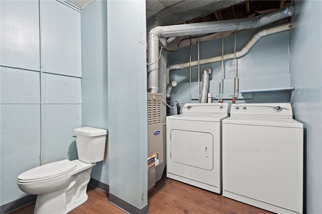 laundry room with wood finished floors, washing machine and dryer, and laundry area