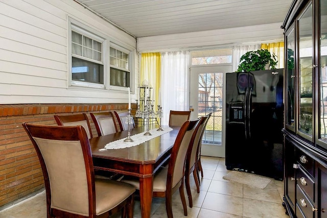 dining room featuring light tile patterned flooring and wooden ceiling