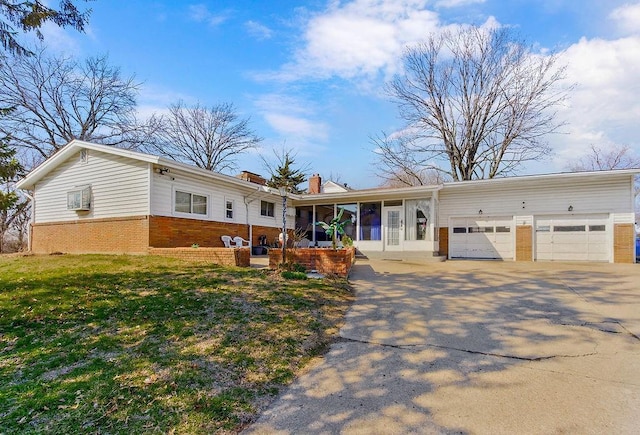 ranch-style house featuring a front lawn, concrete driveway, a garage, brick siding, and a chimney