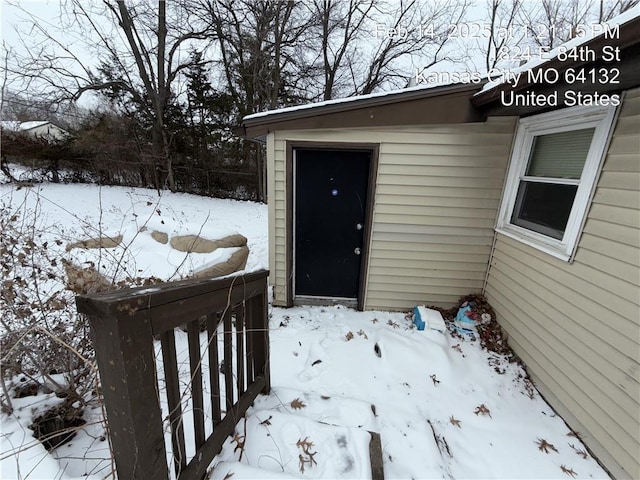 view of snow covered property entrance