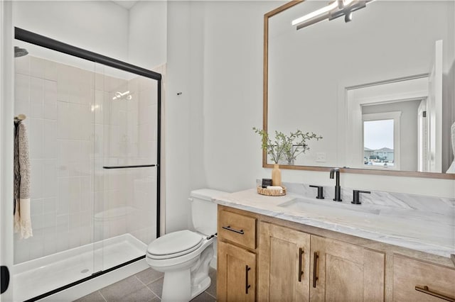 bathroom featuring vanity, tile patterned floors, toilet, and walk in shower