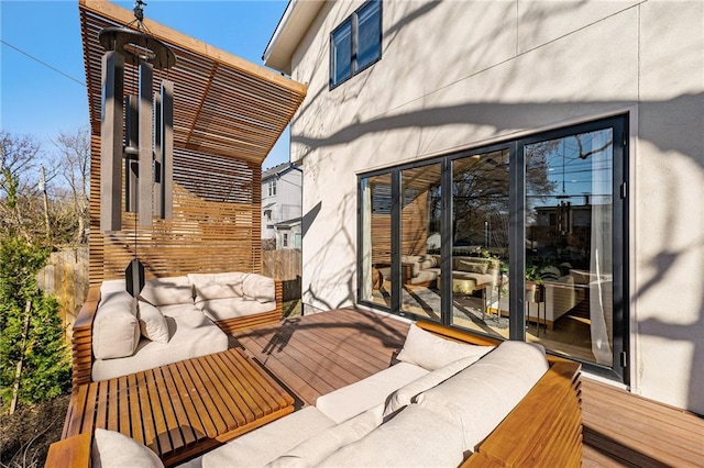 wooden terrace featuring outdoor lounge area and fence