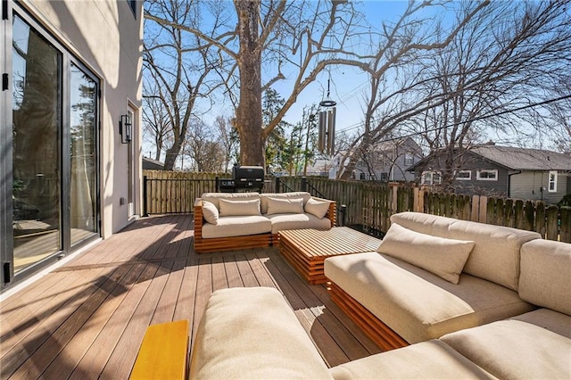 wooden deck featuring an outdoor hangout area and fence