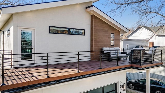 view of side of property with outdoor lounge area and stucco siding