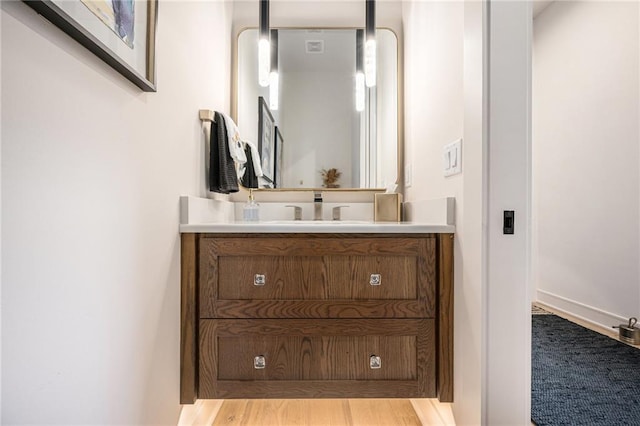 bathroom with vanity and wood finished floors