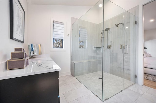 full bath featuring baseboards, vanity, a shower stall, and tile patterned flooring