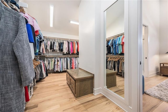 walk in closet with wood finished floors