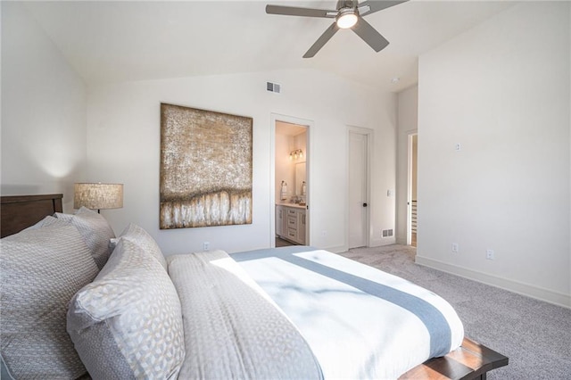 bedroom featuring visible vents, ensuite bath, carpet flooring, baseboards, and vaulted ceiling