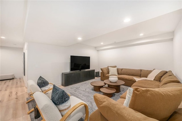 living room with light wood finished floors, recessed lighting, and baseboards