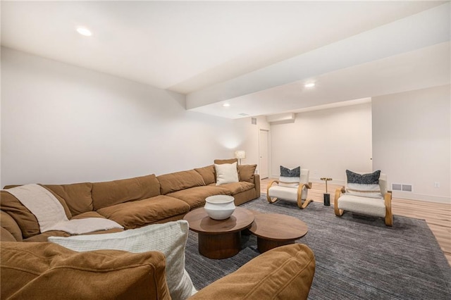 living area with visible vents, recessed lighting, baseboards, and wood finished floors