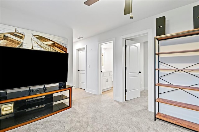 living area with light carpet, ceiling fan, visible vents, and baseboards