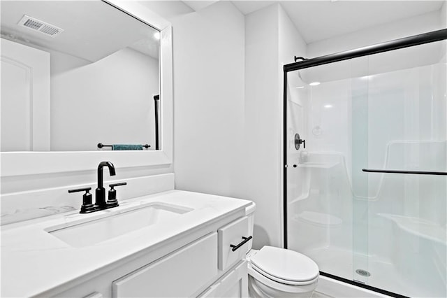 full bathroom with toilet, a shower stall, visible vents, and vanity