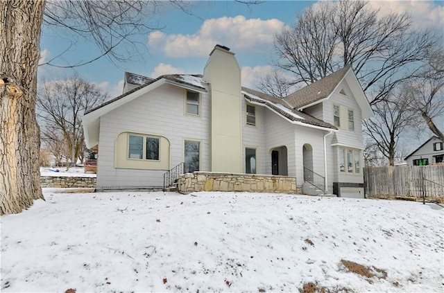 view of snow covered rear of property