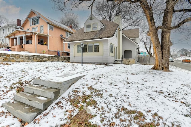 view of snow covered back of property