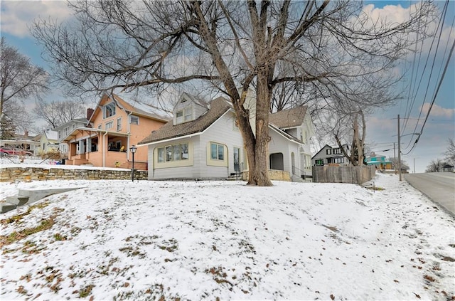 view of snow covered rear of property