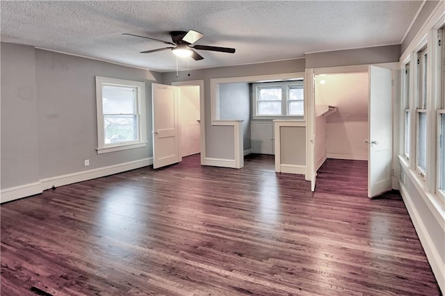 unfurnished bedroom featuring ceiling fan, dark wood-type flooring, and a textured ceiling