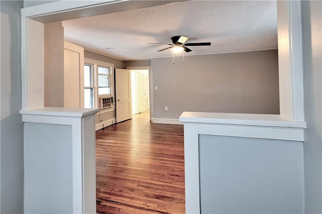 spare room featuring ceiling fan, dark hardwood / wood-style floors, and a textured ceiling