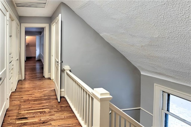 hallway featuring hardwood / wood-style floors and a textured ceiling