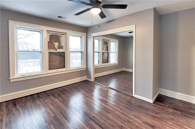 spare room featuring ceiling fan and dark hardwood / wood-style flooring