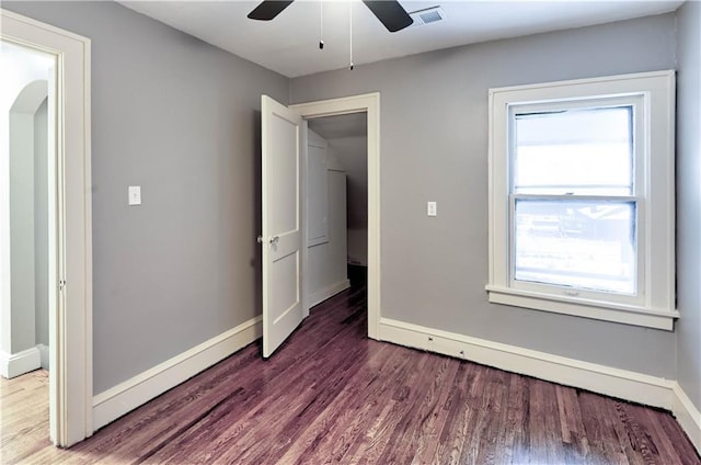 unfurnished bedroom with dark hardwood / wood-style floors and ceiling fan