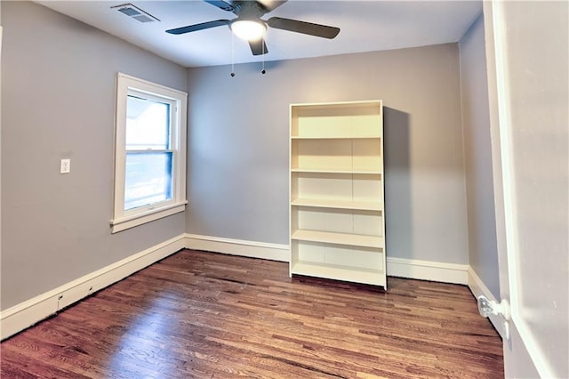 interior space with ceiling fan, dark hardwood / wood-style floors, and a baseboard heating unit