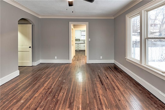 empty room featuring crown molding, ceiling fan, and dark hardwood / wood-style flooring