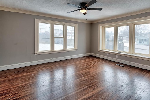 empty room featuring ornamental molding, ceiling fan, a textured ceiling, and dark hardwood / wood-style flooring