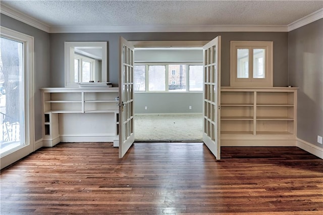 interior space featuring crown molding, dark wood-type flooring, french doors, and a textured ceiling