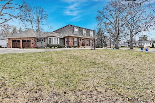 view of front of home with a front yard and a garage