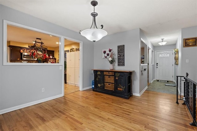 interior space featuring baseboards and wood finished floors