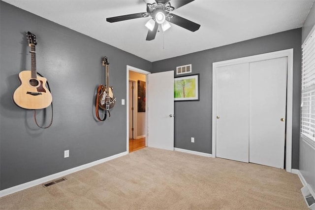 unfurnished bedroom with light carpet, baseboards, visible vents, and a closet