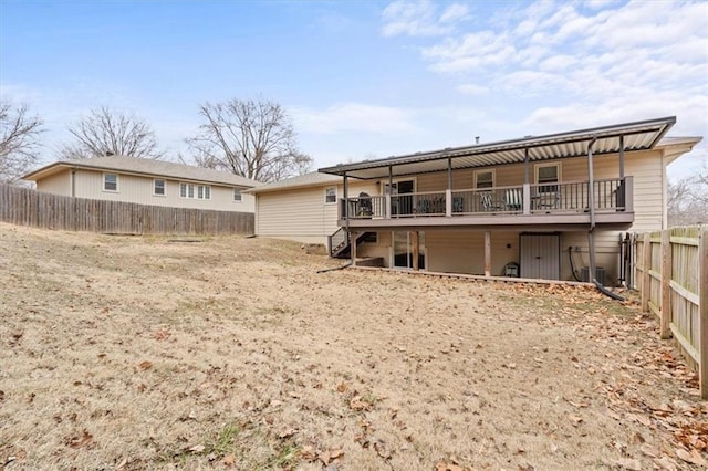 rear view of house featuring a deck, fence private yard, and stairs