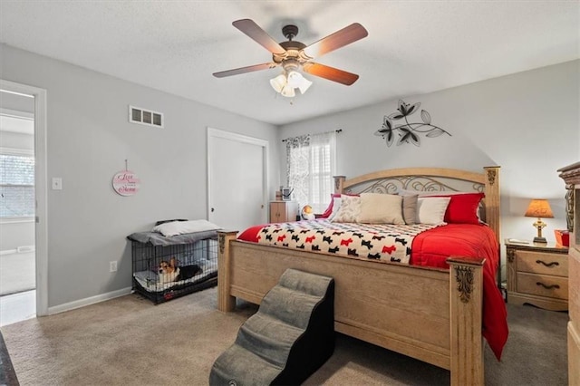 bedroom featuring baseboards, multiple windows, visible vents, and carpet flooring