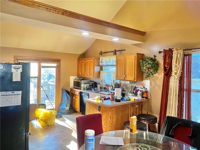 kitchen featuring lofted ceiling, dishwashing machine, freestanding refrigerator, a peninsula, and light countertops