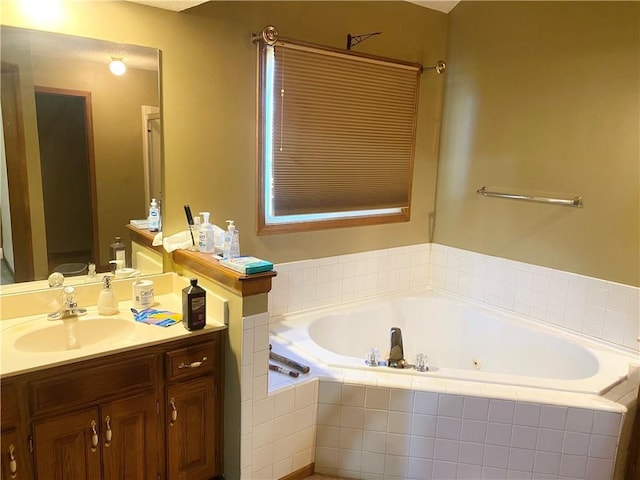 full bathroom featuring a jetted tub and vanity