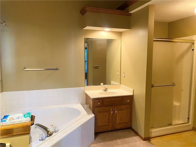 bathroom featuring a shower stall, a tub with jets, a textured ceiling, and vanity