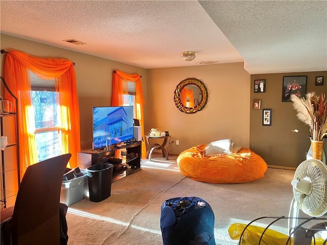 carpeted living area with a textured ceiling, visible vents, and baseboards