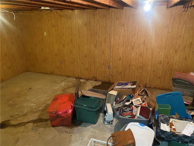 unfinished basement featuring wood walls