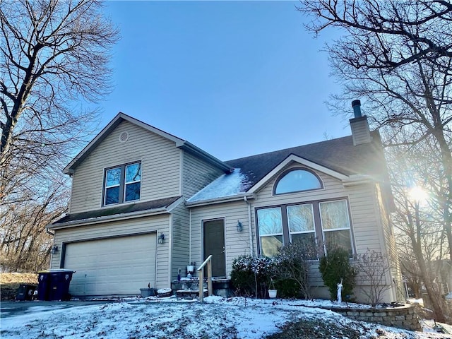 view of front of house with a shingled roof, a chimney, and an attached garage