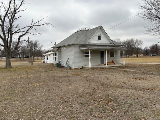 view of front facade with cooling unit and a porch