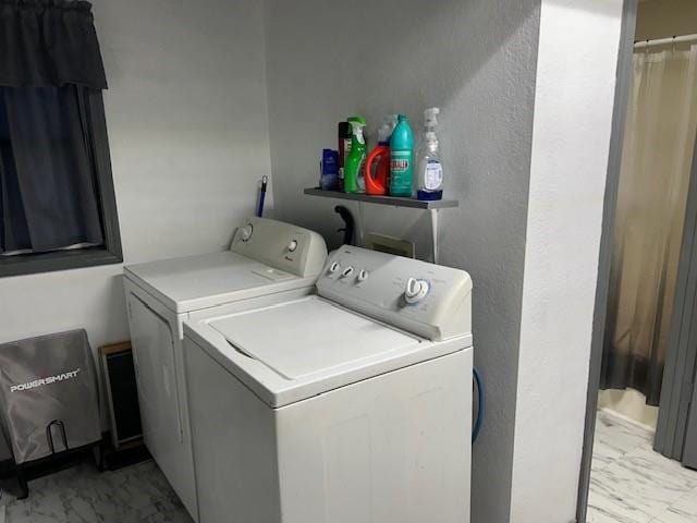 clothes washing area featuring independent washer and dryer