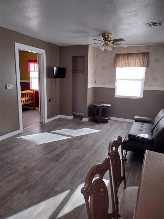 living room featuring hardwood / wood-style floors, a textured ceiling, and ceiling fan