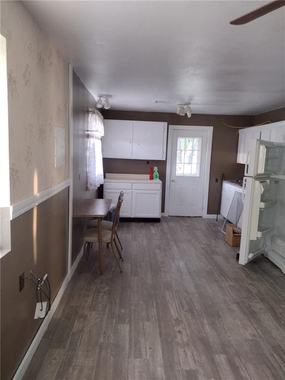 kitchen with dark wood-type flooring and white cabinets