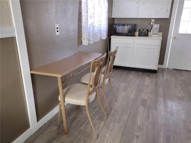 dining space featuring dark wood-type flooring