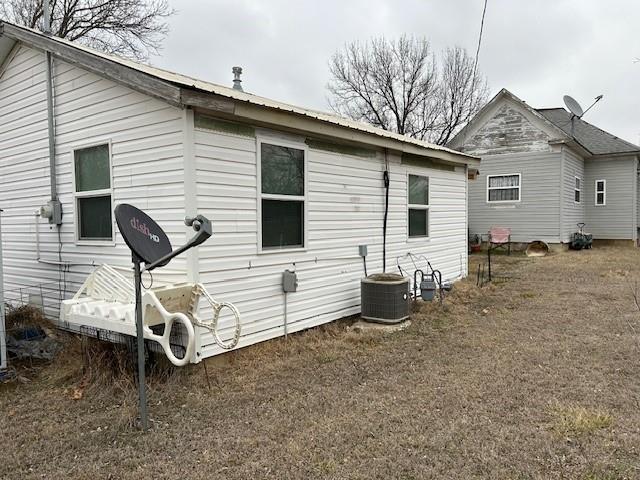 back of house featuring central AC