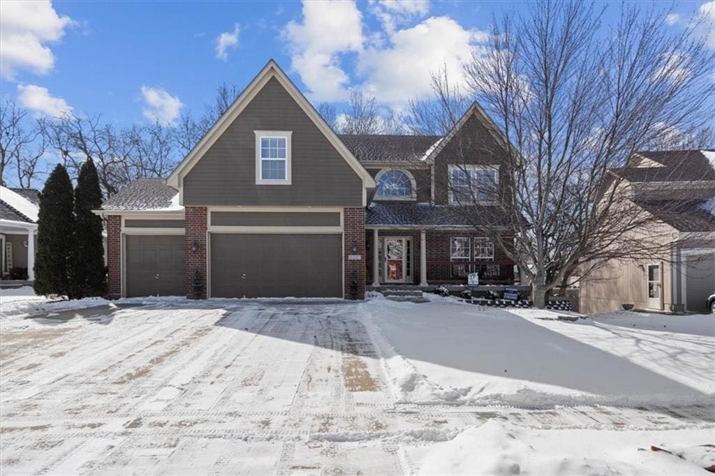 view of front of property featuring brick siding and an attached garage