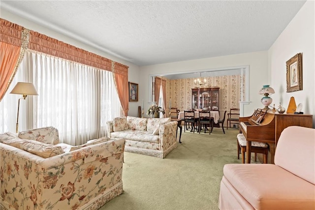 carpeted living area featuring a textured ceiling and a chandelier