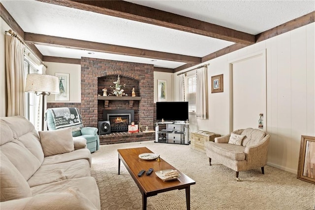 living area with carpet, a brick fireplace, beamed ceiling, and a textured ceiling